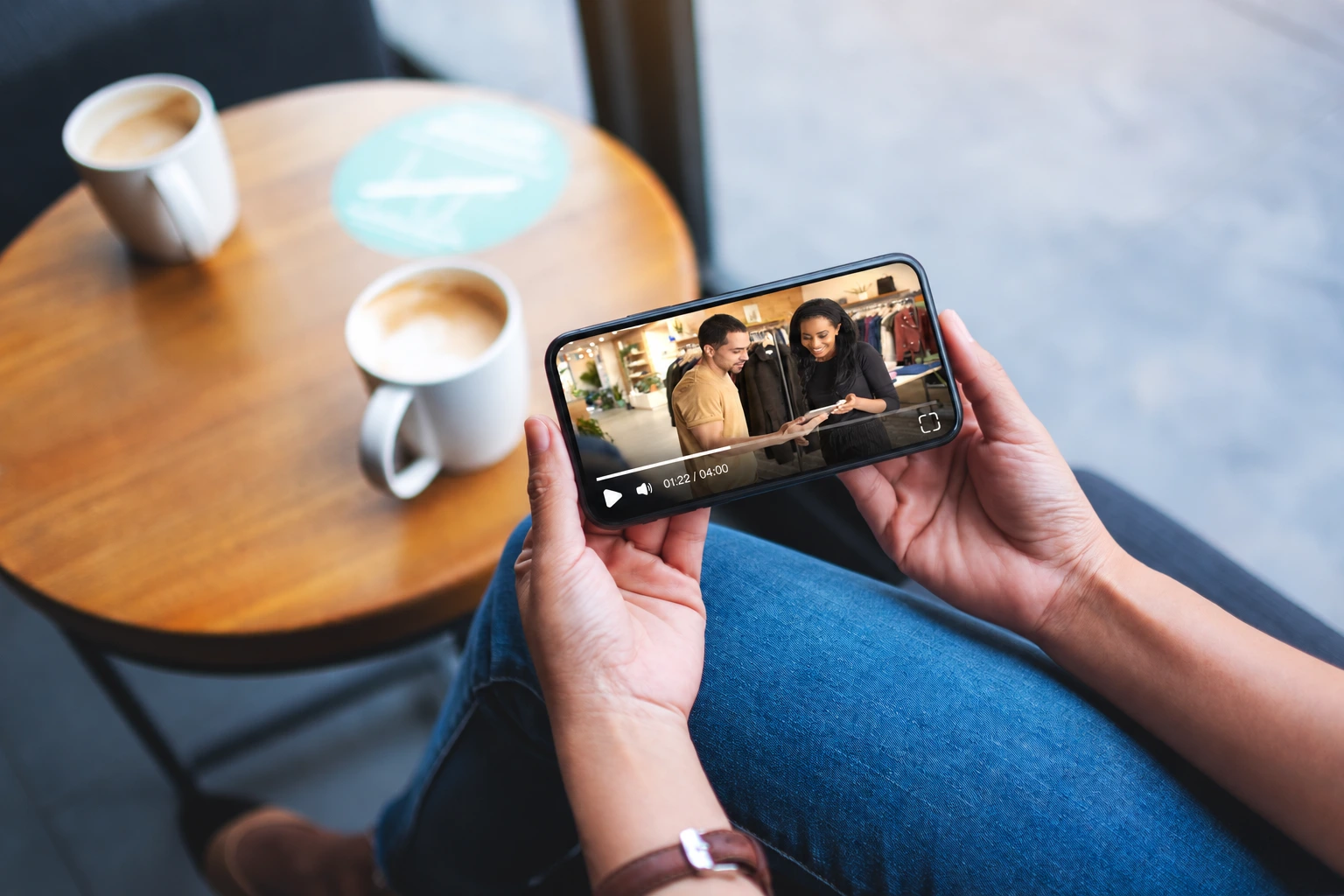 A person watching a training video in the Teamledge player on a landscape phone